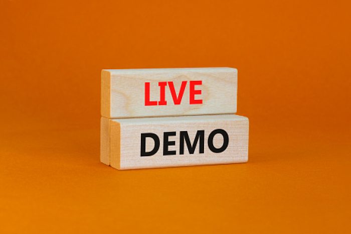 Live demo symbol. Concept words 'live demo' on wooden blocks on a beautiful orange background. Copy space. Business and live demo concept.